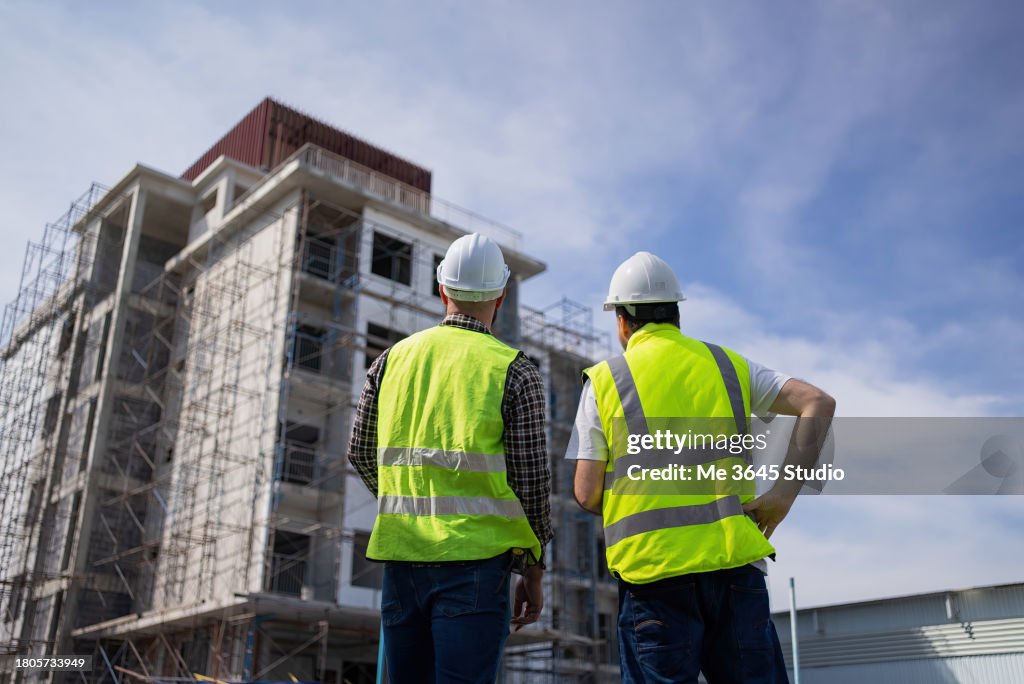 The engineers in the workplace are inspecting the specifications of buildings, apartments, and residences.