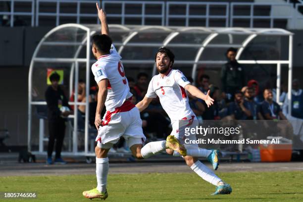 Rustam Soirov of Tajikistan celebrates a goal with 5# Manuchekhr Safarov during the 1st half of 2026 FIFA World Cup AFC Qualifier Group G match...
