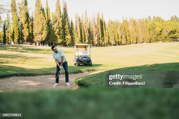 golfer shot from a sand trap - sand trap imagens e fotografias de stock