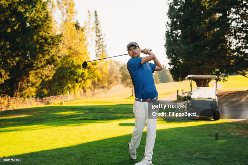 A golfer just after shooting the ball