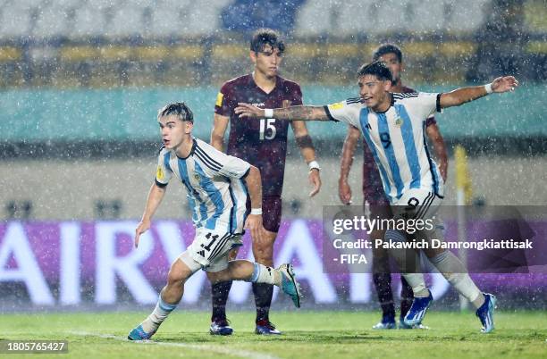 Santiago Lopez and Agustin Ruberto of Argentina celebrate after Luis Balbo of Venezuela scores an own goal to make it the first goal for Argentina...