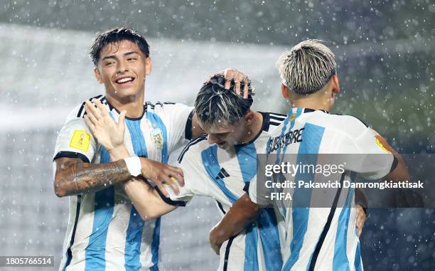 Santiago Lopez and Lan Subiabre of Argentina celebrate after Luis Balbo of Venezuela scores an own goal to make it the first goal for Argentina...