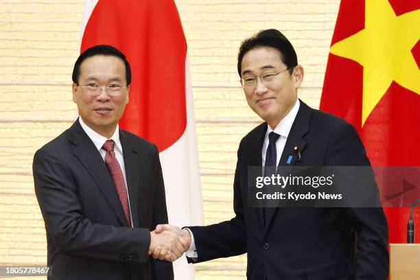 Japanese Prime Minister Fumio Kishida and Vietnamese President Vo Van Thuong shake hands at the end of a joint press conference at the premier's...