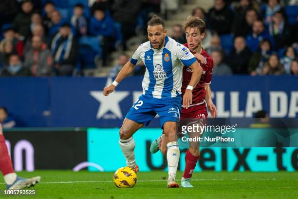 Martin Braithwaite of RCD Espanyol and Javier Castro of AD Alcorcon are competing for the ball during the LaLiga Hypermotion 2023 - 2024 match...