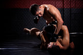 MMA fighter mounting and punching opponent