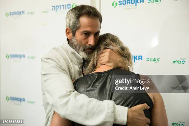 Tali Amano and Roi Avraham the daughter and son of released hostage, Elma Avraham, react during a press conference at Soroka hospital on November 27,...