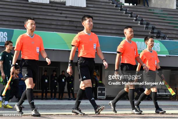 Match officials walk towards the pitch during the 2026 FIFA World Cup AFC Qualifier Group G match between Pakistan and Tajikistan at Jinnah Sports...