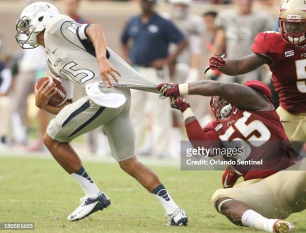 Florida State defensive tackle Jacobbi McDaniel pulls down Nevada quarterback Tyler Stewart during game action at Doak Campbell Stadium in...