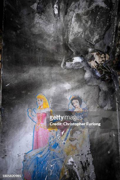 Safety room door painted with Disney characters and destroyed by a grenade stands outside a home after the October 7th Hamas attacks at Kibbutz Kfar...