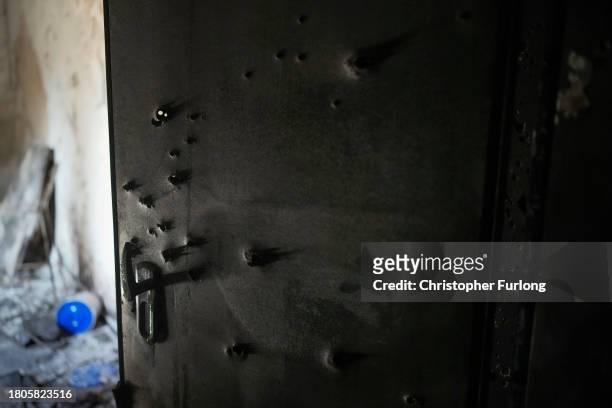 Bullet holes are seen in a safe room door after the October 7th Hamas attacks at Kibbutz Kfar Aza close the Gaza border. Forensic analysis and...