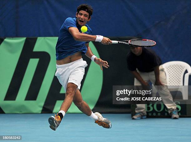 El Salvador's Marcelo Arevalo returns the ball during their Davis Cup doubles match against Venezuela's Luis Martinez and Roberto Maytin on September...