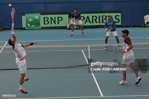 Venezuela's Luis Martinez and Roberto Maytin serve the ball during their Davis Cup doubles match against El Salvador Marcelo Arevalo and Rafael...