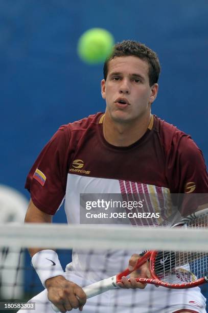 Venezuela's tennis player Luis Martinez returns the ball during their Davis Cup doubles match against El Salvador Marcelo Arevalo and Rafael Arevalo...