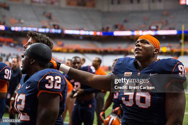 Jay Bromley of Syracuse Orange gathers with teammates to show appreciation to fans following the team's victory over the Wagner Seahawks on September...