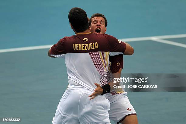 Venezuela's tennis players Roberto Maytin and Luis Martinez celebrate after defeating El Salvador in their Davis Cup doubles match on September 14,...