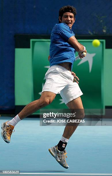 El Salvador's tennis player Marcelo Arevalo returns the ball during their Davis Cup doubles match against Venezuela's Luis Martinez and Roberto...
