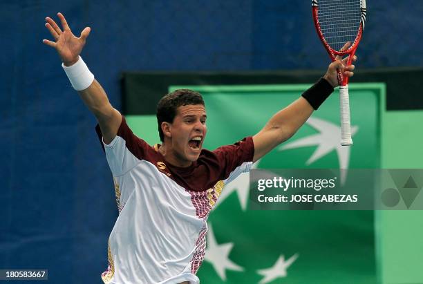 Venezuela's tennis player Luis Martinez celebrates after defeating El Salvador in their Davis Cup doubles match on September 14, 2013 in San...