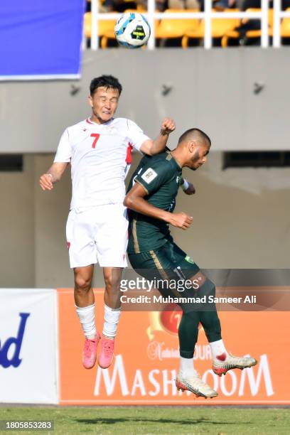 Parvizdzhon Umarbaev of Tajikistan tries to give a header with Harun Ar-Rashid Faheem of Pakistan during the 2026 FIFA World Cup AFC Qualifier Group...