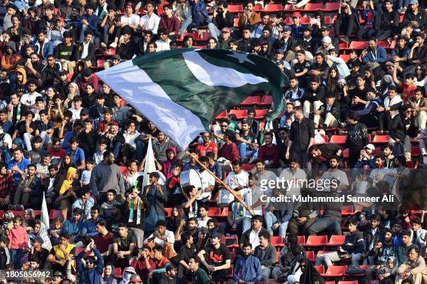 Members of the crowd cheer and wave a flag of Pakistan during the 2026 FIFA World Cup AFC Qualifier Group G match between Pakistan and Tajikistan at...