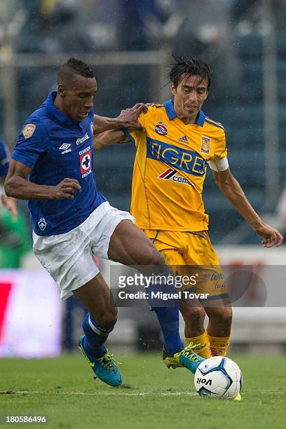 Luis Amaranto of Cruz Azul fights for the ball with Lucas Lobos of Tigres during a match between Cruz Azul and Tigres as part of the Apertura 2013...