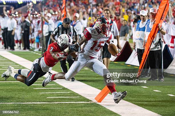 Wide receiver Nicholas Norris of the Western Kentucky Hilltoppers runs the ball in for a touchdown in front of safety Charles Watson of the South...