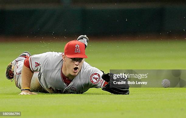 Mike Trout of the Los Angeles Angels of Anaheim dives but can't make the catch on a shallow fly ball hit by Matt Dominguez of the Houston Astros in...