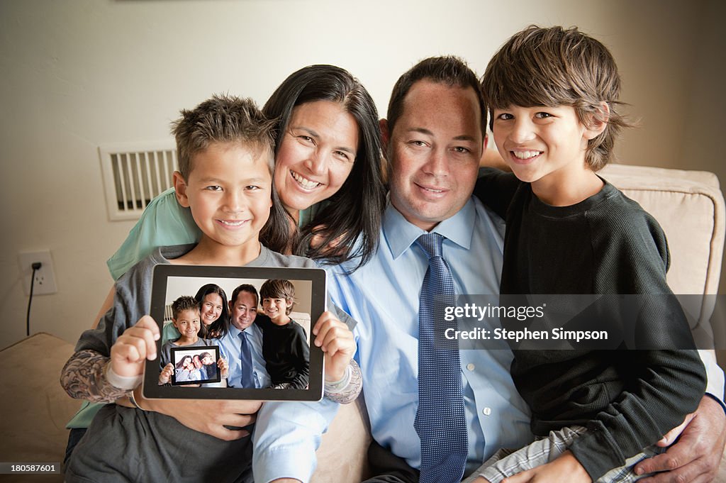 Family making/sharing photos on tablet computer