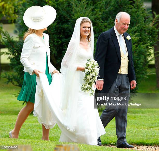 Lady Laura Marsham accompanied by her father Julian Marsham, Earl of Romney arrives for her wedding to James Meade at the Parish Church of St....