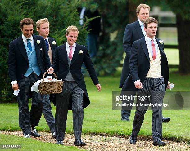 James Meade accompanied by his groomsmen Tom van Straubenzee and Guy Pelly arrives for his wedding to Lady Laura Marsham at the Parish Church of St....