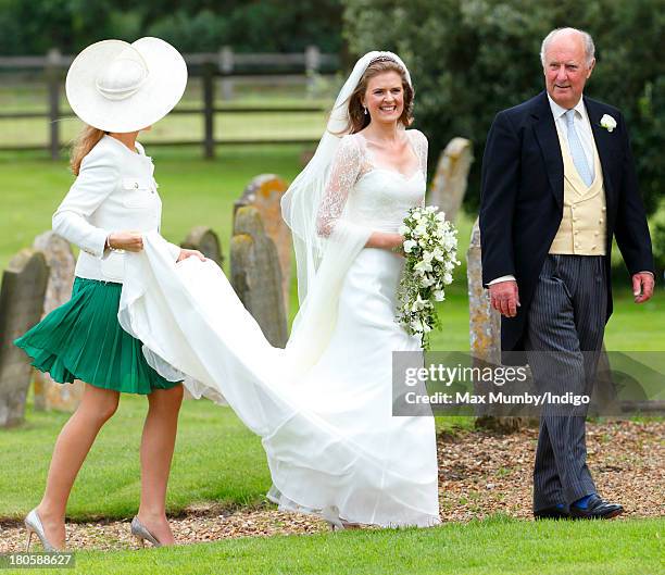 Lady Laura Marsham accompanied by her father Julian Marsham, Earl of Romney arrives for her wedding to James Meade at the Parish Church of St....