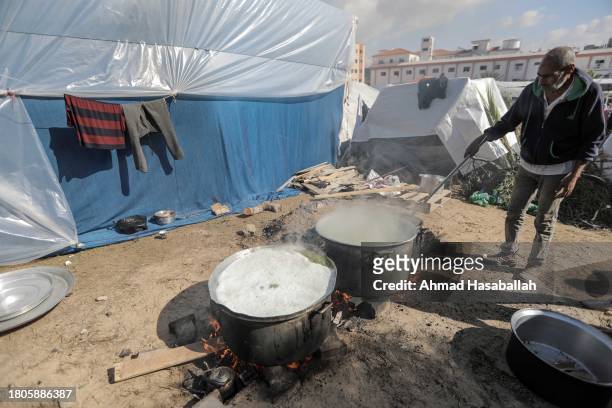 Palestinian citizen cooks food and distributes it to displaced people coming from Gaza City on November 21, 2023 in Khan Yunis, Gaza. More Gaza...