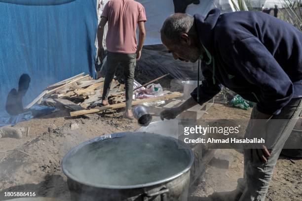 Palestinian citizen cooks food and distributes it to displaced people coming from Gaza City on November 21, 2023 in Khan Yunis, Gaza. More Gaza...