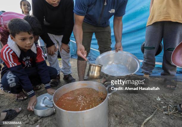 Palestinian citizen cooks food and distributes it to displaced people coming from Gaza Cityon November 21, 2023 in Khan Yunis, Gaza. More Gaza...