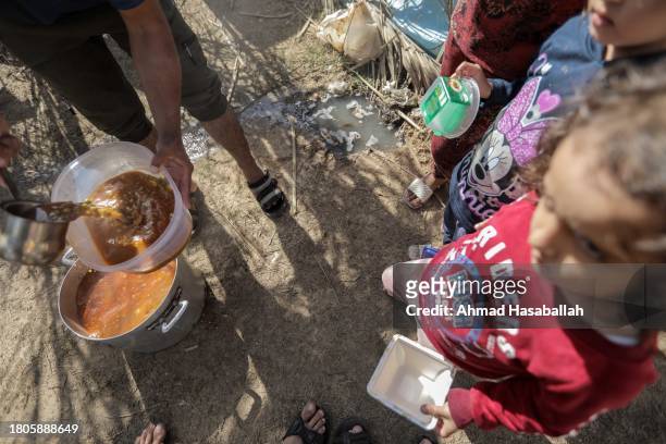 Palestinian citizen cooks food and distributes it to displaced people coming from Gaza Cityon November 21, 2023 in Khan Yunis, Gaza. More Gaza...