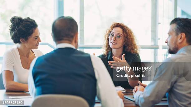 young businesswoman talking on a meeting - conversation stock pictures, royalty-free photos & images