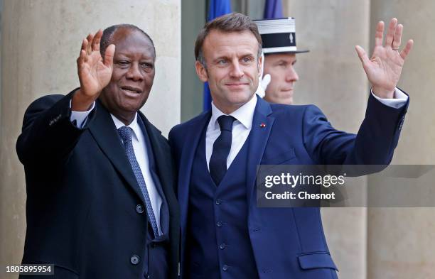 French President Emmanuel Macron greets Ivory Coast President Alassane Ouattara upon his arrival prior to a lunch at the Elysee Palace on November...