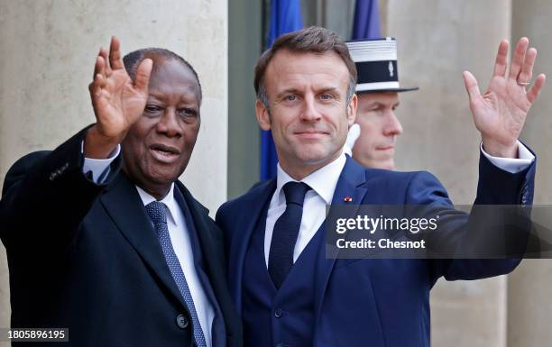 French President Emmanuel Macron greets Ivory Coast President Alassane Ouattara upon his arrival prior to a lunch at the Elysee Palace on November...