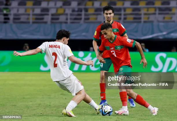 Fouad Zahouani of Morocco and Nima Andarz of IR Iran battle for the ball during the FIFA U-17 World Cup Round of 16 match between Morocco and IR Iran...