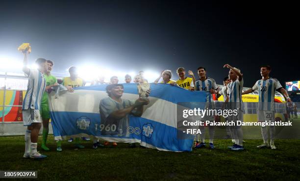 Players of Argentina celebrate with a banner of Diego Maradona following the team's victory in the FIFA U-17 World Cup Round of 16 match between...