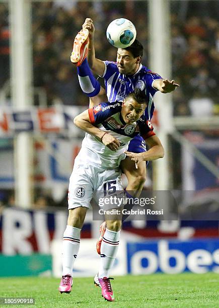 Hector Villalba of San Lorenzo fight for the ball with Federico Lertora of Godoy Cruz during a match between San Lorenzo and Godoy Cruz as part of...