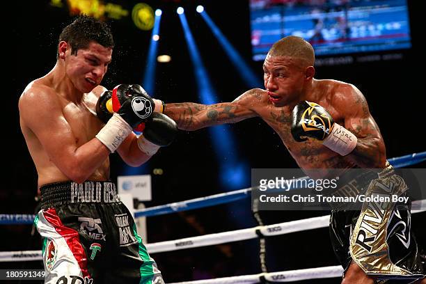 Ashley Theophane throws a right at Pablo Cesar Cano during their welterweight fight at the MGM Grand Garden Arena on September 14, 2013 in Las Vegas,...