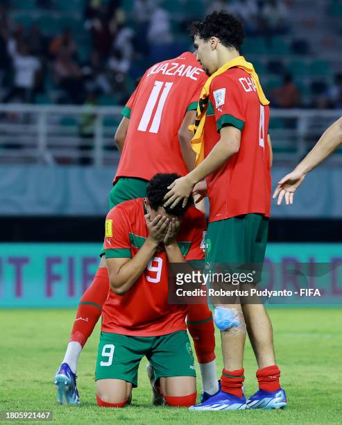 Nassim Azaouzi of Morocco celebrates with teammates Zakaria Quazane and Ayoub Chaikhoun after scoring the team's first goal during the FIFA U-17...