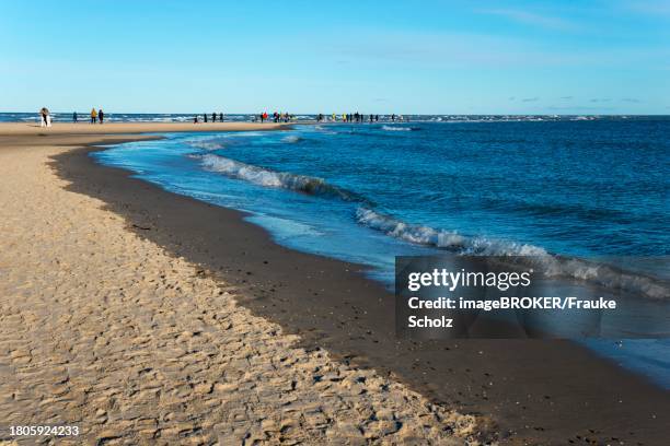 people on headland, meeting of north sea and baltic sea, skagerrak and kattegat, grenen, skagens gren, skagen, north jutland, jutland, denmark - grenen stock pictures, royalty-free photos & images