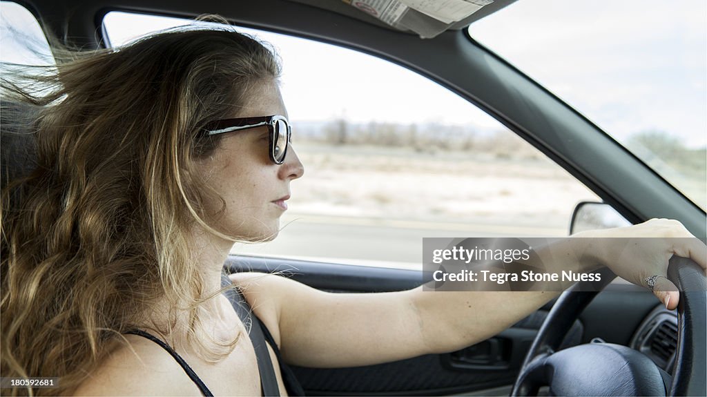 A woman driving on the open road.