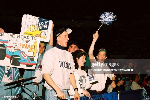 University of Connecticut's basketball fans hold up signs and cheer for the Huskies, New York, 1994.