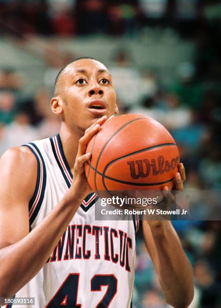 University of Connecticut basketball player Donyell Marshall shoots a free throw at the foul line during a game, Storrs, Connecticut, 1994.