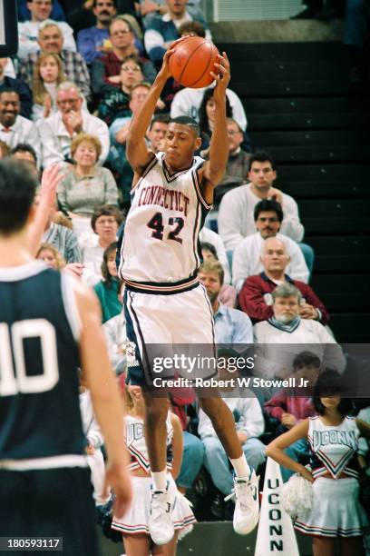 University of Connecticut basketball player Donyell Marshall pulls down a rebound during a game, Storrs, Connecticut, 1994.