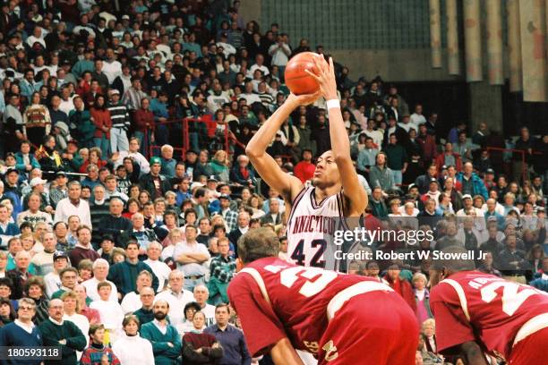 University of Connecticut basketball player Donyell Marshall shoots a free throw at the foul line during a game, Storrs, Connecticut, 1994.