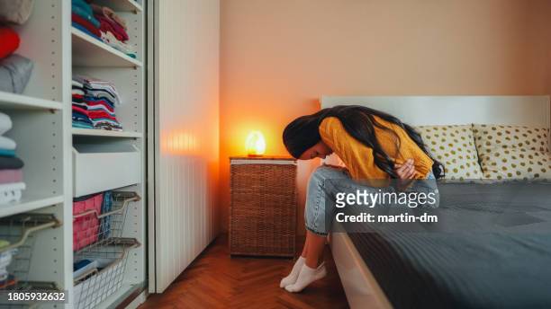 woman with stomach pain staying home - ghosted stock pictures, royalty-free photos & images