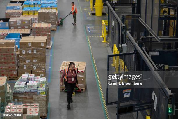 Workers prepare packages for shipping at an Amazon Fulfillment center on Cyber Monday in Robbinsville, New Jersey, US, on Monday, Nov. 27, 2023. An...